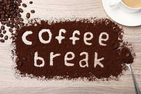 Phrase Coffee Break written in powder on wooden table, flat layの写真素材