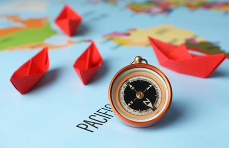 Bright paper boats and compass on world mapの写真素材