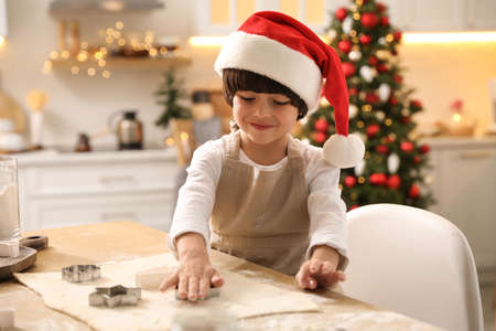 Cute little boy making Christmas cookies in kitchenの写真素材
