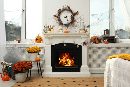 Modern room with fireplace decorated for Halloween. Festive interiorの写真素材