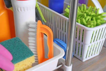Different cleaning supplies on wooden table in kitchen, closeupの写真素材