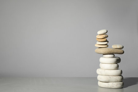 Stack of stones on gray background, space for text. Harmony and balance conceptの写真素材