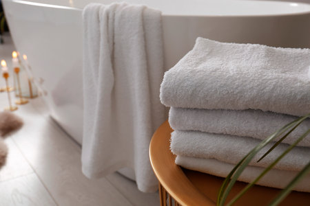 Fresh clean terry towels on table in bathroom. Space for textの写真素材