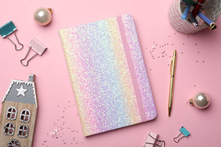 Bright planner, stationery and festive decor on pink background, flat lay. New Year aimsの写真素材