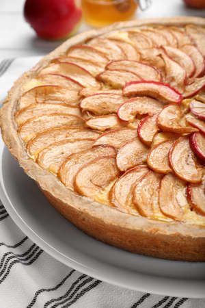 Tasty apple pie on white striped tablecloth, closeupの写真素材