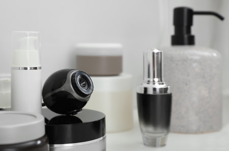 Camera hidden among different toiletries on table in bathroomの写真素材
