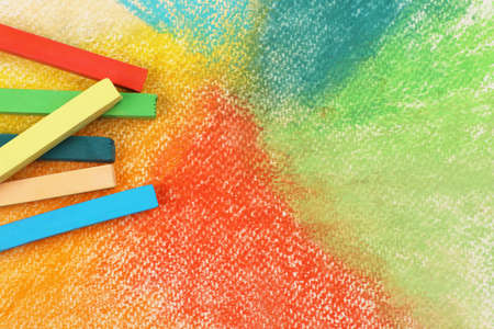 Colorful pastel chalks on abstract drawing, flat lay. Space for textの写真素材