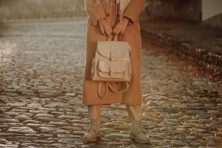 Young woman with stylish beige backpack on city street, closeupの写真素材