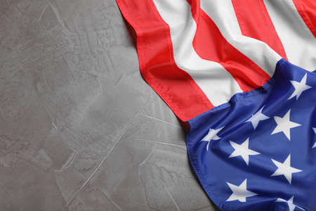 American flag on light gray background, top view. Space for text