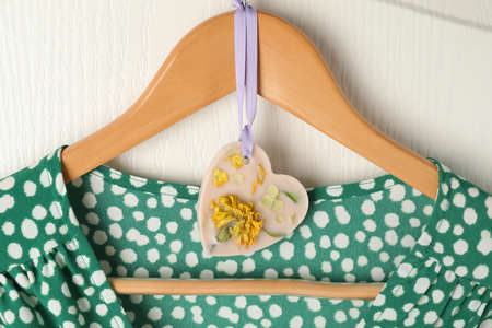 Scented sachet with flowers and stylish clothes on hangerの写真素材