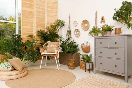 Room interior with stylish furniture and green plants