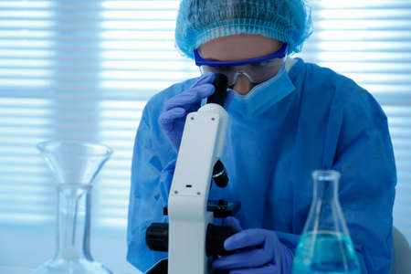 Scientist working with microscope in laboratory. Medical research