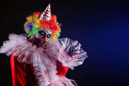 Terrifying clown on dark background, space for text. Halloween party costumeの写真素材