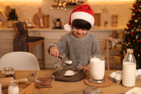 Cute little boy making Christmas cookies in kitchenの写真素材
