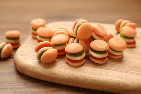 Delicious gummy burger shaped candies on wooden table, closeupの写真素材