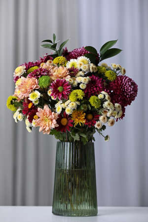 Bouquet of beautiful chrysanthemum flowers on table in roomの写真素材