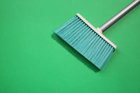 Plastic broom on green background, top view. Space for textの写真素材