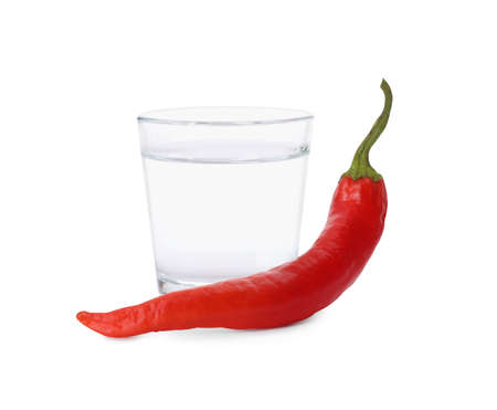 Red hot chili pepper and vodka in shot glass on white backgroundの写真素材