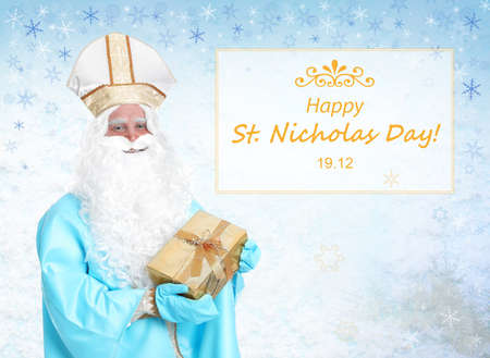 Greeting card design. Saint Nicholas with present on light backgroundの写真素材