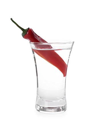 Red hot chili pepper and vodka in shot glass on white backgroundの写真素材
