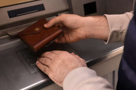 Man entering cash machine pin code, closeupの写真素材