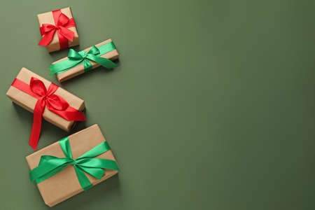 Many gift boxes on dark green background, flat lay. Space for textの写真素材