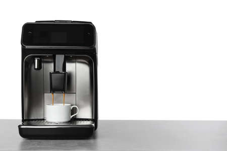 Making coffee with modern espresso machine on table against white background. Space for textの写真素材