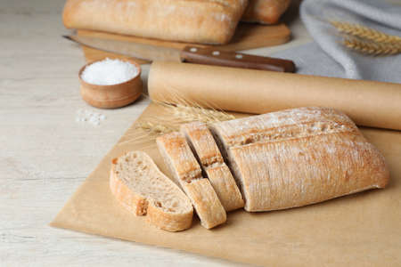 Fresh crispy ciabatta on white wooden tableの写真素材