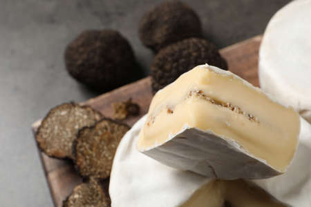 Delicious fresh truffle cheese on gray table, closeup. Space for textの写真素材