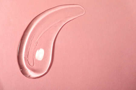 Sample of transparent cosmetic gel on pink background, top view. Space for textの写真素材