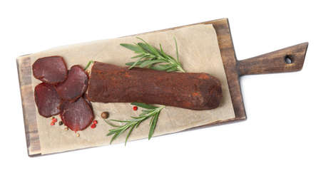 Delicious dry-cured beef basturma with rosemary and peppercorns on white background, top viewの写真素材