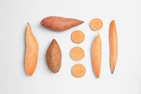 Cut and whole sweet potatoes on white background, top viewの写真素材