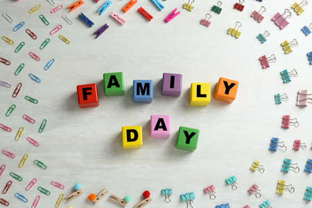 International Family day. Flat lay composition with cubes, binder clips and clothespins on white...