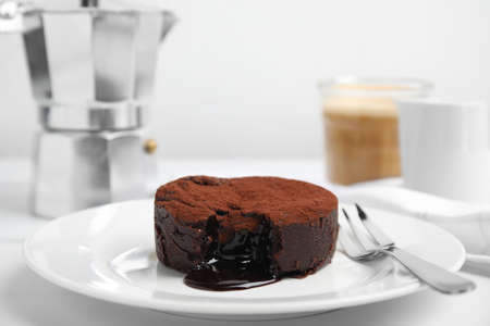 Delicious fresh fondant with hot chocolate served on white tableの写真素材