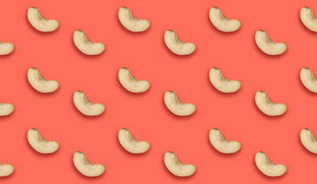 Many tasty cashew nuts on coral background, flat lay. Banner designの写真素材