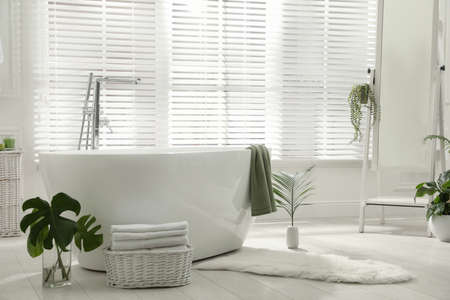 Stylish bathroom interior with green plants. Home design