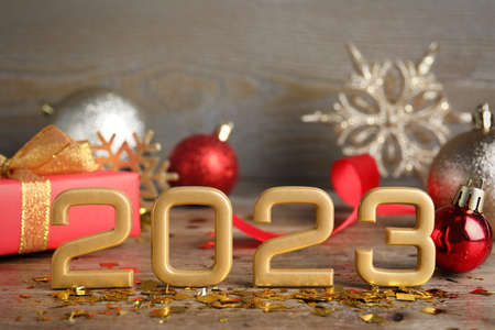 Golden number 2023 and festive decor on wooden table. Happy new yearの写真素材