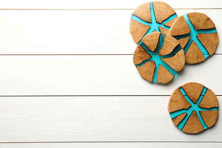 Stylish wooden cup coasters on white table, top view. Space for textの写真素材