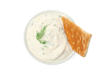 Tasty creamy dill sauce with cracker in bowl isolated on white, top viewの写真素材