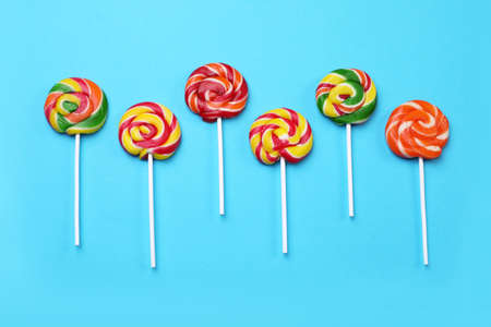 Sweet lollipops on light blue background, flat layの写真素材