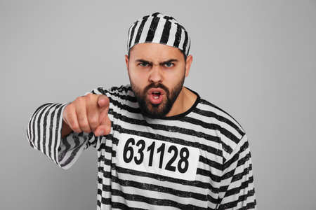 Emotional prisoner in special uniform on gray backgroundの写真素材