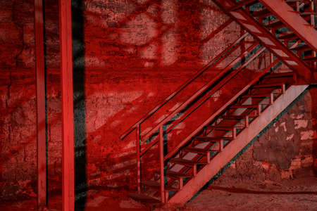 Old building with fire escape, toned in redの写真素材