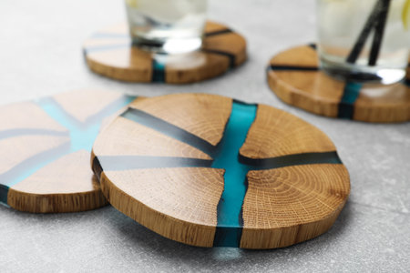 Stylish wooden cup coasters on light gray table, closeupの写真素材