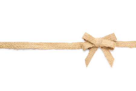 Burlap ribbon with pretty bow on white background, top viewの写真素材