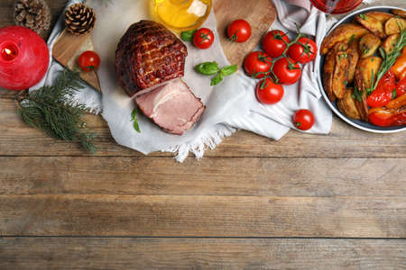 Festive flat lay composition with delicious ham on wooden table, space for text. Christmas dinnerの写真素材