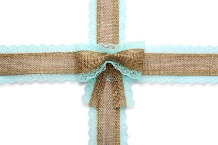 Burlap ribbons and bow with light blue lace on white background, top viewの写真素材