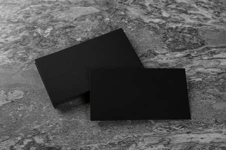 Blank black business cards on gray background, above view. Mockup for designの写真素材