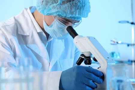 Scientist working with microscope in laboratory. Medical research