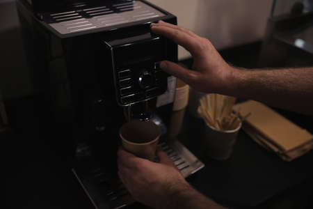 Barista preparing fresh aromatic coffee on modern machine, closeupの写真素材