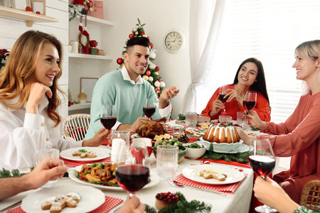 Happy family with their friends enjoying festive dinner at home. Christmas eve celebrationの写真素材